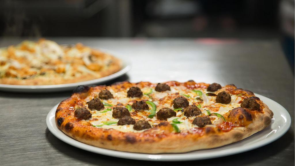 Monster Pizza · Gourmet Italian sausage, meatball, pepperoni, Canadian bacon, onion, black & green olives, mushroom & green pepper with tomato and bacon on top of a thin crust with a rolled edge.