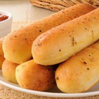 Fp'S Famous Breadsticks · Oven baked garlic breadsticks lacquered with garlic butter and served with marinara sauce.