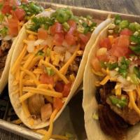 Bbq Taco Trio · One pulled pork, one pulled chicken and one brisket taco each topped with cheddar cheese, di...