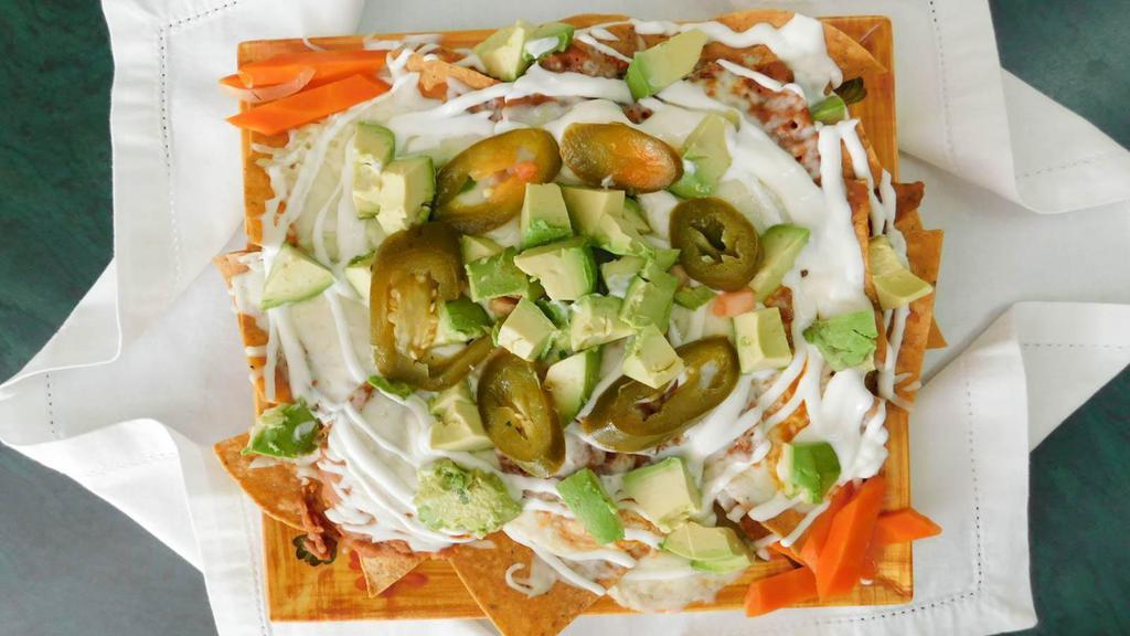 Super Nachos · Served with cheese, beans, sour cream, guacamole, jalapeños and meat