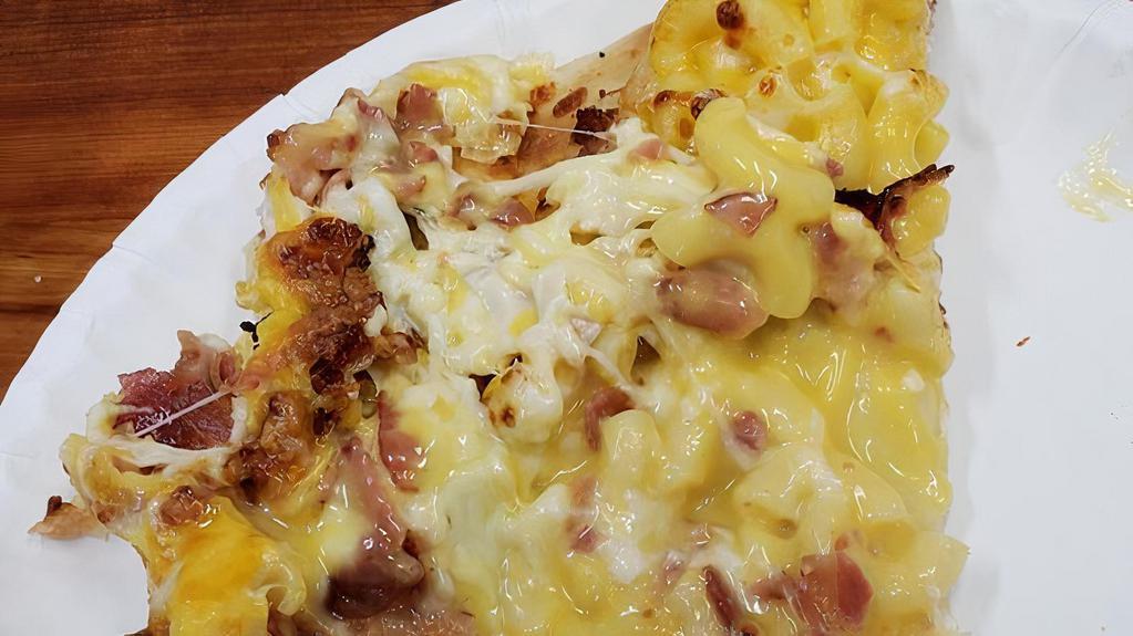 Mac- N- Cheese Pizza · Macaroni and cheese based pizza topped with bacon and three cheese blend.