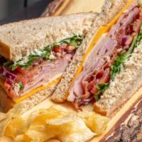 Café Club · Sliced turkey and ham, bacon, Cheddar and Swiss cheese, lettuce, tomato, onion, and mayonnai...