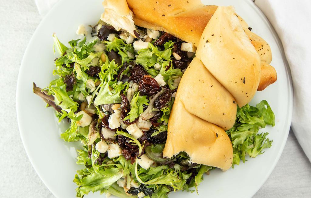 Traverse City Salad · Fresh greens, Traverse City dried cherries, toasted pine nuts and Gorgonzola cheese tossed with a roasted shallot vinaigrette.