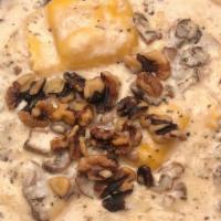 Butternut Ravioli · Stuffed with butternut squash pureé, walnuts and exotic mushrooms in a creamy marsala sage s...