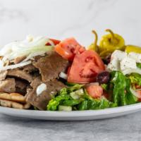 Greek Salad · Crispy lettuce, tomatoes, cucumbers, feta cheese, black olives, peppers, onions and oregano.
