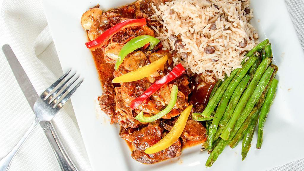 Oxtail · Oxtail pieces seasoned with Jamaican spices, browned, and stewed with butter beans.