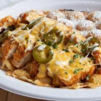 Chick-In Queso · Crispy buttermilk chicken drenched in our homemade Monterey-Jack Queso Jalapenos and chives ...