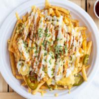 Queso Fries · Crispy fries drenched in our signauture Monterey-Jack Queso sauce,shredded cheddar cheese, J...