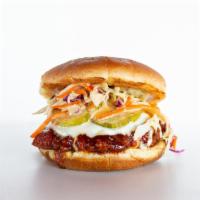 Nashville Hot Chicken Sandwich · CRISPY BUTTERMILK CHICKEN DIPPED IN OUR SPICY NASHVILLE SAUCE TOPPED WITH CHEESE , SLAW AND ...