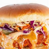 Buffalo Sandwich · CRISPY BUTTERMILK CHICKEN DIPPED IN OUR SPICY BUFFALO SAUCE TOPPED WITH CHEESE , SLAW AND PI...