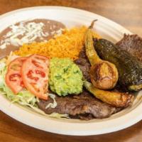 Carne Asada · Skirt steak. Served with salad, rice and beans.