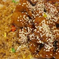 Sesame Chicken · Served with fried rice and 1 egg roll or 3 crab rangoon.