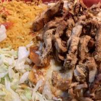 Chilaquiles · Corn tortillas cooked in red or green sauce, topped with shredded chicken or beef. Served wi...