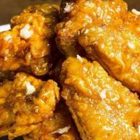 Honey Garlic Wings · A soy based sauce that is sweet and savory infused with pungent pieces of garlic.