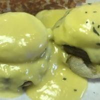 Eggs Benedict · Two poached eggs, ham on a grilled muffin topped with hollandaise sauce.