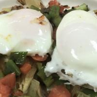 Veggie Benedict · Two poached eggs, mushrooms, green peppers, onions, tomatoes on a grilled muffin topped with...