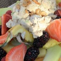 Bird Of Paradise · Homemade chicken salad in a pineapple boat. Topped with cashews, seasonal berries and melon ...