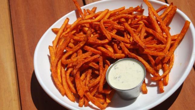 Sweet Potato Fries · Shoes string sweet potato fries, seasoned with Cajun boom spice and side of avocado poblano dressing.