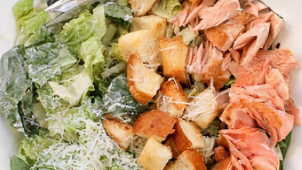 Salmon Caesar Salad · Fresh cut romaine, grilled salmon, Parmesan cheese, and croutons.