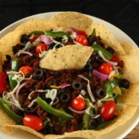 Taco Salad · Nacho chips, salad greens, cheese, black olive, red onion, green peppers tomato, and spicy g...