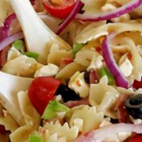 Zesty Pasta Salad · Penne pasta tossed with Italian dressing, veggies, and Parmesan on a bed of fresh romaine wi...