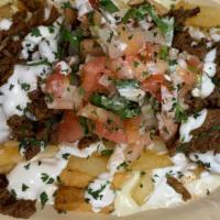 Cheese Steak Fries · Fries covered with queso, steak, pico de gallo, sour cream, topped with parsley.