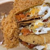Crispy Lunch Special · 3 Crispy Tacos with lettuce, tomatoes, cheddar cheese and sour cream; served with rice and b...