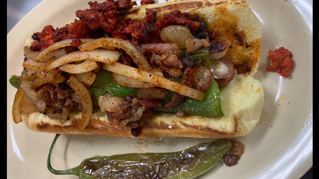 Hotdogs · Hotdog polish, stuffed with queso, wrapped in whole green chili topped with bacon, chorizo, grilled onions and jalapeños. Mayonnaise, ketchup and mustard.