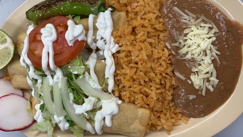Flauta Lunch Special · 3 Chicken flautas covered with lettuce, tomatoes, onions, sour cream and parmesan cheese; served with rice and beans.