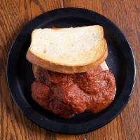 Meatballwich · Open-faced meatball sandwich smothered with homemade spaghetti sauce on Italian bread.