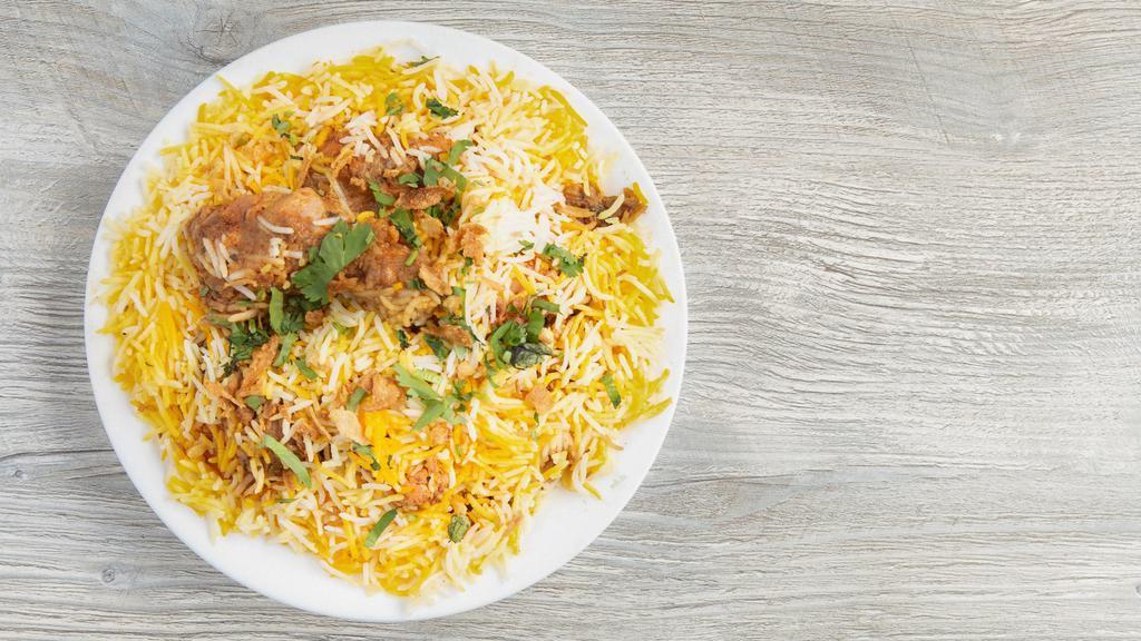 Chicken Biryani · Saffron basmati rice cooked with marinated flavorful pieces of chicken legs and thighs.