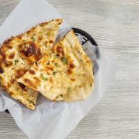 Garlic Naan · Clay oven baked fluffy white bread stuffed with garlic and lightly brushed with butter.
