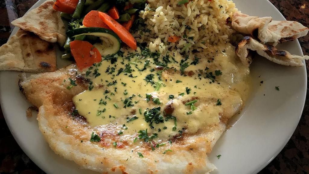 Lemon Sole · fillet of sole baked with fresh herbs and a touch of bread crumbs then topped with a lemon, olive oil garlic butter sauce. Served with rice pilaf and vegetables.