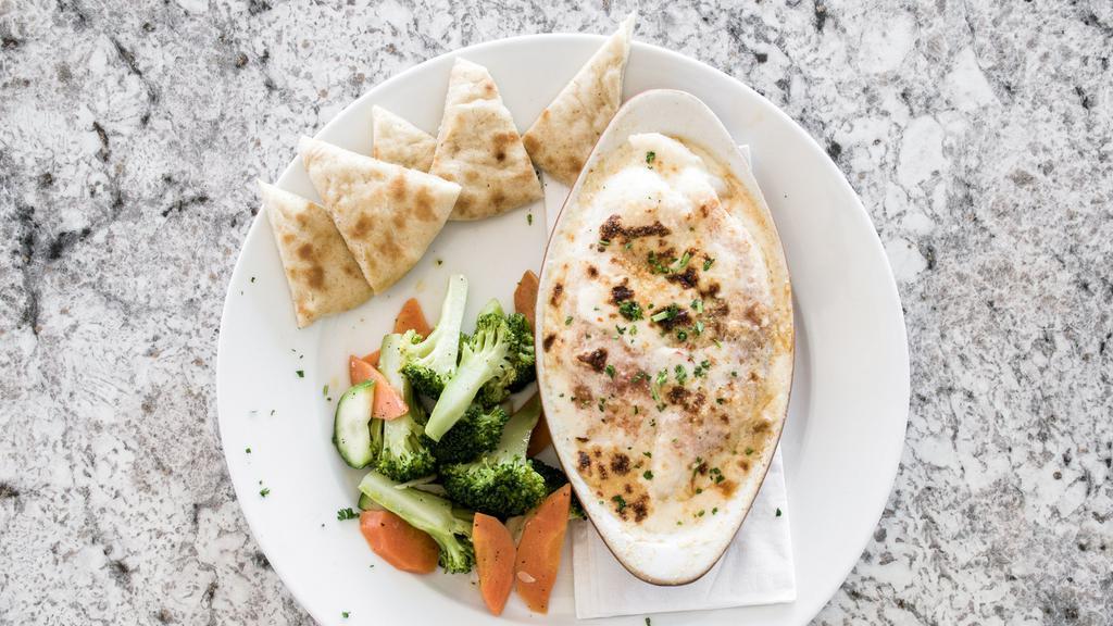 Stuffed Flounder · Flounder stuffed with mixed seafood then baked in light creamy cheese sauce. Served with rice pilaf and vegetables.