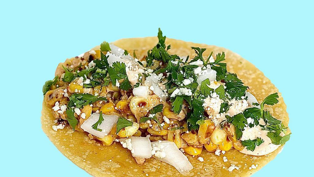 Elotes Tacos · Grilled street corn in a taco. Finished with chipotle crema, cotija  cheese, onions y cilantro.