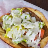 Gyro · Gyro meat, onions, lettuce, tomatoes and cucumber sauce.