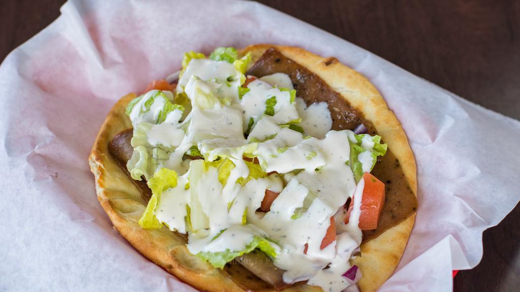Gyro · Gyro meat, onions, lettuce, tomatoes and cucumber sauce.
