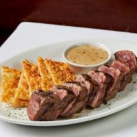 Sliced Prime Long Island Strip Steak · Served with parmesan crisps and bourbon peppercorn sauce