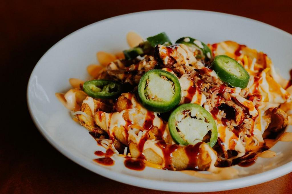 Dirty Fries · potato dippers, colby jack cheese, queso, caribbean bbq sauce, jalapenos, chipotle mayo