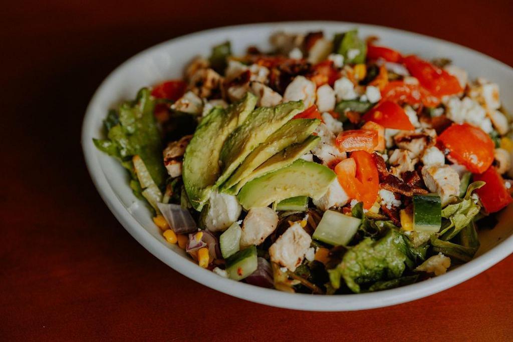 Charlie'S Chop Salad · grilled chicken, mixed greens, applewood smoked bacon, corn, sliced avocado, crumbled feta, diced tomato, cucumber, cranberry vinaigrette