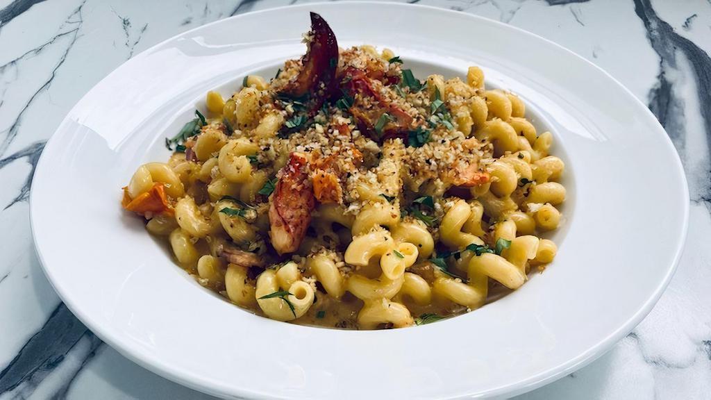 Lobster Mac And Cheese · creamy cheese sauce, chunk lobster meat, roasted tomatoes, bacon, cavatappi pasta, parmesan breadcrumbs.