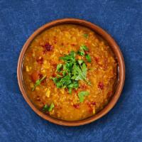 Lucid Yellow Lentil · Cumin and garlic tempered yellow lentil with onion and tomatoes served with a side of basmat...