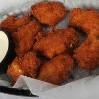 Chicken Wings · Eight breaded and seasoned wings deep fried and served with our homemade ranch.