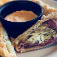 Reuben Egg Rolls · Two hand wrapped wonton rolls stuffed with corned beef, Swiss cheese, and coleslaw. Served w...