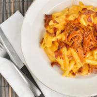 Southern Mac And Cheese · Penne noodles tossed with Wisconsin cheddar, American and gorgonzola cheeses. Topped with Bo...