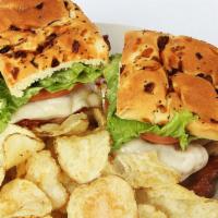 Hobo Chicken Sandwich · Grilled Amish chicken topped with avocado, bacon, provolone, lettuce, and tomato served on a...