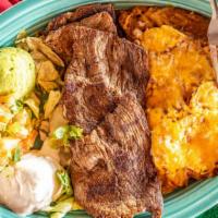 Carne Asada · Thinly sliced Beef Sirloin served with Papas Rancheras, Refried Beans, guacamole, sour cream...