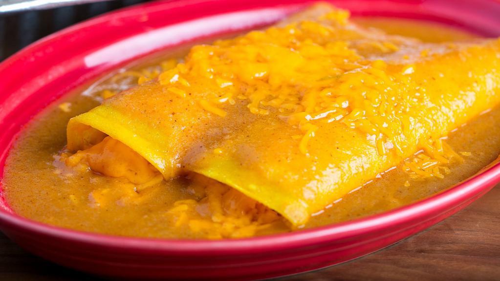 Enchiladas De Pollo · Two chicken enchiladas topped with a gravy style seasoned tomato sauce & melted cheddar cheese. Served with your Spanish rice, refried beans or black beans.