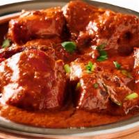 Chicken Tikka Masala · Chicken tikka cooked with specialty made delicious thick sauce. Served with naan or rice.
