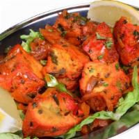 Chicken Tikka · Cubes of boneless chicken marinated in herbs and cooked in clay oven. Served with naan or ri...